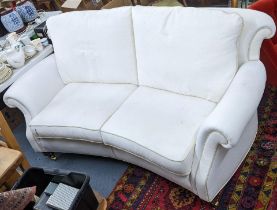 A Brights of Nettlebed white upholstered three seater sofa on front turned legs with castors, 90cm h