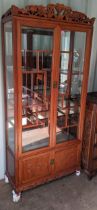 A late 20th century Chinese hardwood display cabinet with glazed and panelled doors Location: CON B