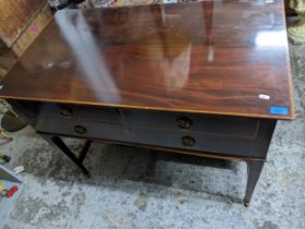 A reproduction mahogany side table with inlaid crossbanded top edge, over four short drawers, on