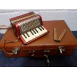 A small vintage Hohner accordion in red A/F with leather shoulder strap together with a vintage