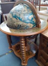 A 1940's style drinks cabinet in the form of a globe. Location:RAM Condition: Areas of missing paper