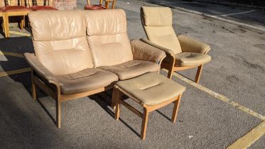A model Swedish retro beech framed and tan leather three piece suite compromising of a reclining