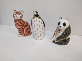 Three Royal Crown Derby gold seal paperweights to include a red cat, a penguin and a panda Location:
