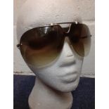 Christian Dior-A pair of late 20th Century gold tone over-sized aviator style frameless sunglasses