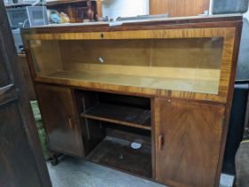 An early 20th century walnut side cabinet, crossbanded top over a full front glazed cupboard door,