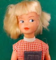 A 1970's Patch in a jean dungaree with red checked top outfit, blonde hair together with a Brownie