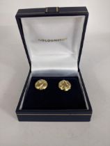 A pair of 9ct gold earrings with an abstract design on the circular face, 1.8g Location: