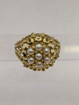 A yellow metal cluster style ring set with pearls, tested as 18ct gold, 5.1g Location: