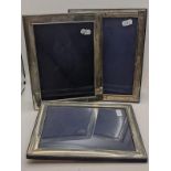 Three large silver photograph frames to include one having a reeded border and easel backs Location: