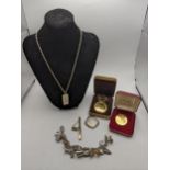 Mixed costume jewellery to include a gold plated necklace, horse shoe brooch, locket, tie clip and