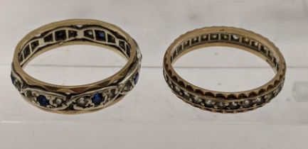Two 9ct gold eternity rings, one set with blue and white sapphires, one set with white sapphires,