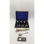 A cased set of six silver coffee spoons hallmarked Birmingham 1910, with one other silver spoon,