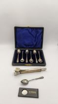 A cased set of six silver coffee spoons hallmarked Birmingham 1910, with one other silver spoon,