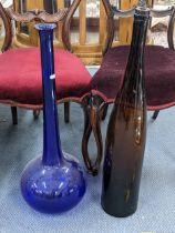 A large Bristol blue glass bottle vase, 70cm h, and a brown glass bottle Location: A2F