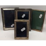 Four silver photograph frames to include one having an engine turned border, hallmarked Birmingham