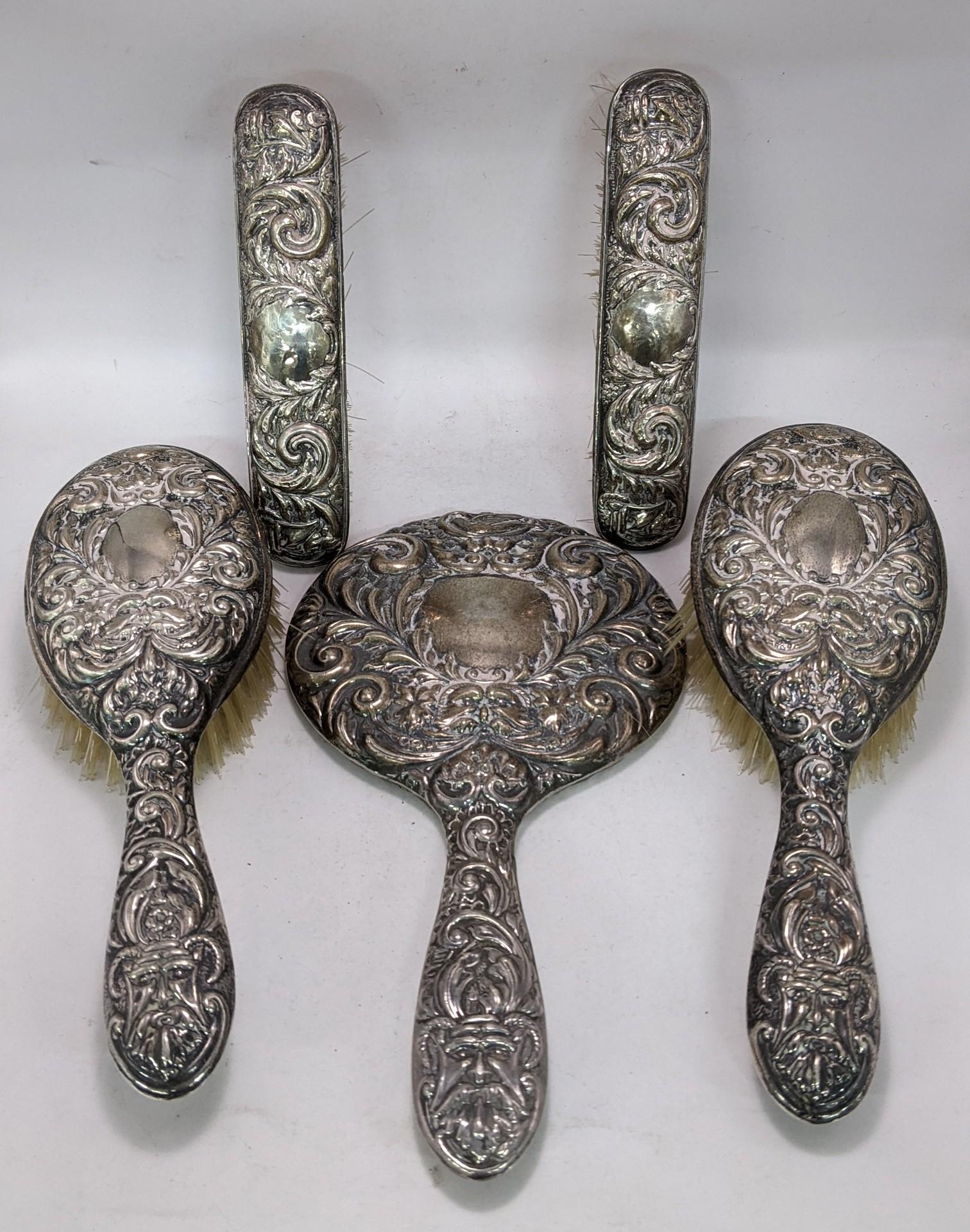 A silver backed dressing table set with an embossed decoration Location: