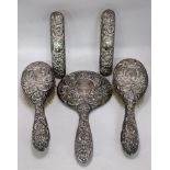 A silver backed dressing table set with an embossed decoration Location: