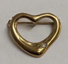 A yellow metal heart shaped brooch inset with a single diamond, 2g Location: