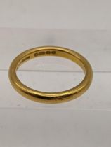 A 22ct gold wedding band, total weight 5.8g Location: