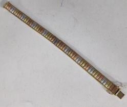 A 9ct gold tri-coloured bracelet with bronze, silver and gold colours on a push clasp, 19.8g