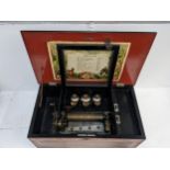 An early 20th century faux grained wood cased musical box with ten airs and three bells, comb