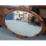 An Arts & Crafts oak framed oval wall mirror Location: RWB