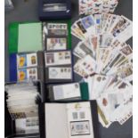 A quantity of first day covers housed in 1 box and 4 albums dating 1980's-2008 to include