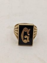 A 9ct gold signet ring set with a non-precious stone inscribed with the letter 'G', 5.0g Location:
