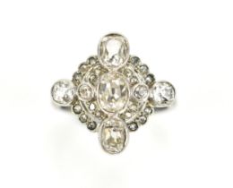 An Art Deco diamond cocktail ring, set with bezel set old mine cut diamonds, the central stone