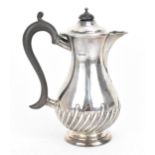 An Edwardian silver hot water pot by James Deakin & Sons, Sheffield 1910, of baluster form with part