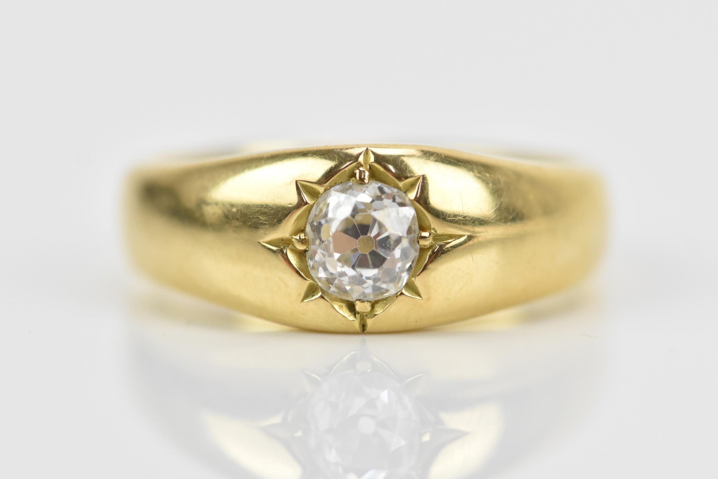 An 18ct yellow gold and diamond gypsy ring, with central old European cut diamond, hallmarked to