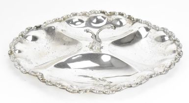 A Mexican silver appetizer dish, of oval form with c-scroll border, four wells, with central