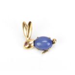 A 9ct yellow gold, ruby and chalcedony rabbit brooch, modelled with a cabochon blue chalcedony