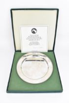 An Elizabeth II silver commemorative plate designed by Doris Lindner in commemoration of the