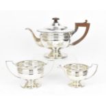 A George V silver three piece tea set by Martin Hall & Co Ltd, Sheffield 1920, comprising a