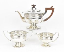 A George V silver three piece tea set by Martin Hall & Co Ltd, Sheffield 1920, comprising a