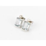 A pair of 9ct white gold, diamond and aquamarine earrings, set with central step cut aquamarine