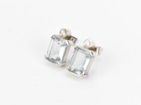 A pair of 9ct white gold, diamond and aquamarine earrings, set with central step cut aquamarine