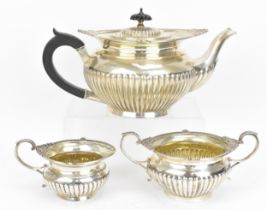 A George V silver three piece tea set by Walker & Hall, Sheffield 1917, comprising a teapot, twin-