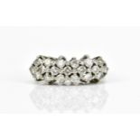 A white metal and diamond three row dress ring, with nineteen pave set brilliant cut diamonds,