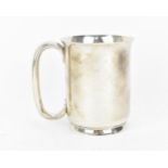 A Victorian silver tankard by George Unite, Birmingham 1886, of plain form with everted rim, hoop