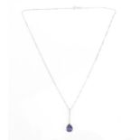 A white metal, iolite and diamond drop pendant on chain, the pendant set with a central pear