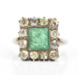 A diamond and emerald cocktail ring, with central square step cut emerald in a halo of twelve
