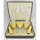 A cased silver and yellow enamel dressing table set by Henry Clifford Davis, Birmingham 1930,