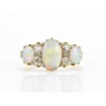 An Art Deco 18ct yellow gold, platinum, diamond and crystal opal dress ring, set with a central oval