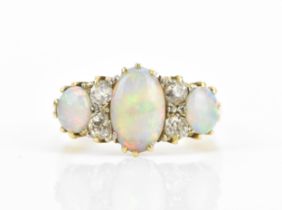 An Art Deco 18ct yellow gold, platinum, diamond and crystal opal dress ring, set with a central oval