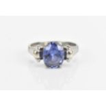 A 9ct white gold and tanzanite dress ring, set with central oval stone in a four claw setting with