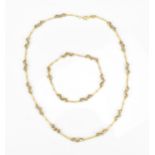 An 18ct Italian yellow gold matching necklace and bracelet, each with textured tubular and faceted