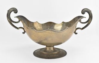 A large Edwardian silver fruit bowl by Josiah Williams & Co, London 1907, of boat form with scrolled