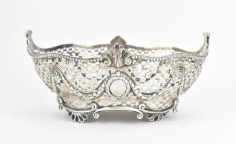 A late Victorian silver fruit basket by Charles Stuart Harris, London 1894, with moulded beaded
